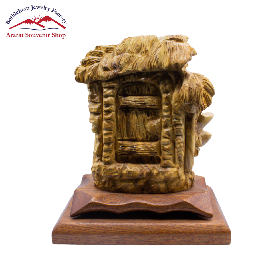 A wooden sculpture of "Behold, I stand at the Door and Knock" on a sturdy base.