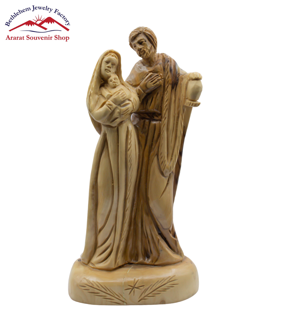 A statue of The Holy Family with a mountain in the background.